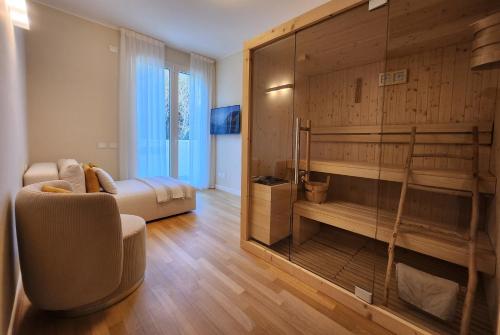 a room with a bedroom with a bed and a couch at Borgo Vico Luxury Suites in Como