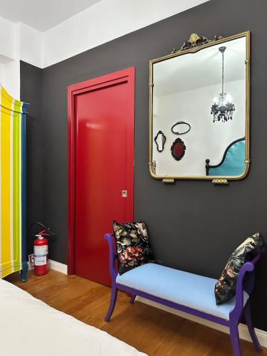 a room with a red door and a mirror at a casa di Emma in Grosseto