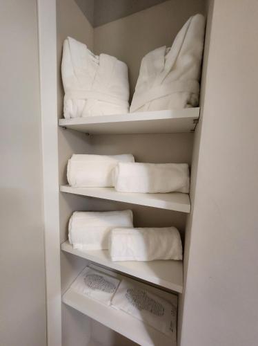 a closet filled with lots of white towels at Borgo Vico Luxury Suites in Como
