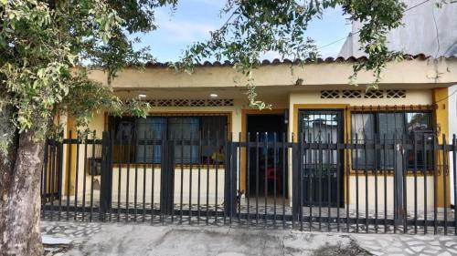 a yellow building with a black fence in front of it at Casa Candido, cerca al CC Único y al Aeropuerto in Neiva