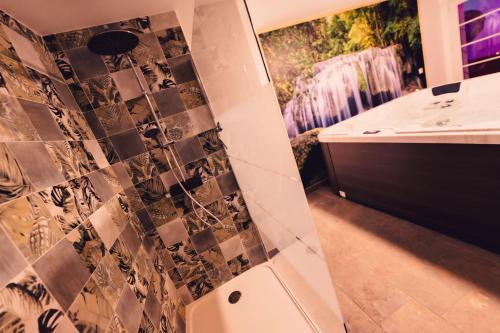 a bathroom with a shower and a sink at Love room L'écrin tropical in Aubers