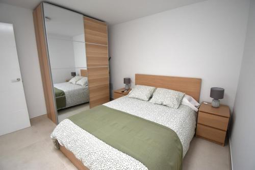 a bedroom with a bed and a large mirror at Nicole Home in Playa Blanca