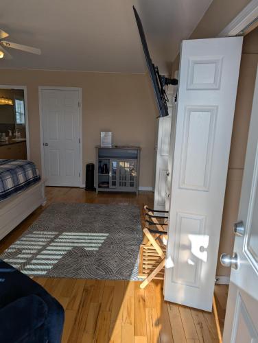 an open door in a living room with a refrigerator at Salish B&B and Spa in West Kelowna