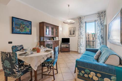 a living room with a table and a blue couch at Domus 21 Near Alassio Beach - Happy Rentals in Alassio