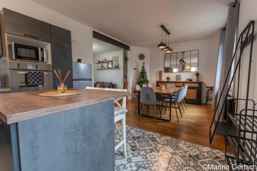 a kitchen and living room with a table and chairs at " La belle vie ", Demeure de charme en Champagne in Dormans