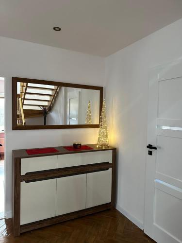 a dressing room with a mirror and a dresser at Gorgeous nook in Góry Wysokie