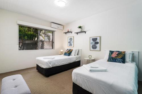 a bedroom with two beds and a window at Canal Luxury Living & Boat Ramp in Gold Coast