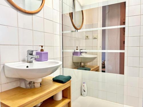 a bathroom with a sink and a mirror at Creux de l'Église - 2 Appartements cosy, 2 Salles de Bains, 8 personnes in Saint-Chamas