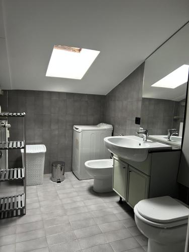 a bathroom with a sink and a toilet and a tub at Residenza Il Carducci in Bergamo