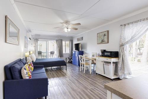 a living room with a couch and a table at Sea La Vie in Edisto Island