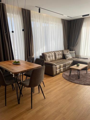 a living room with a table and a couch at Apartman Foresta Divčibare in Divčibare