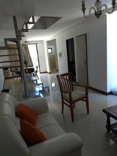 a living room with a couch and a table and chairs at Hermoso triplex concordia in Concordia