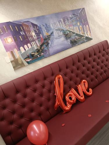 a couch with a balloon and a sign that says love at Dal Doge - Guest House in Chioggia