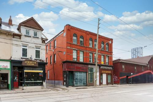 an old red brick building on a city street at New Elegant Suite for 8 w Patio - Heart of Toronto in Toronto