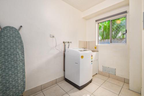a white refrigerator in a room with a window at Canal Luxury Living & Boat Ramp in Gold Coast
