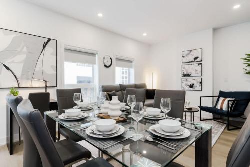 a dining room with a glass table and chairs at Modern Suite 3 min to Transit Downtown Toronto in Toronto
