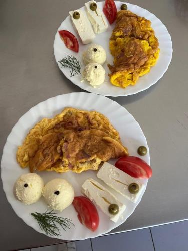 two white plates of food on a table at Ribnjak Filopivic in Pleš