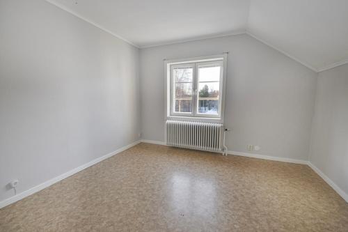 an empty room with a window and white walls at Central two-room apartment with a large balcony in Junsele