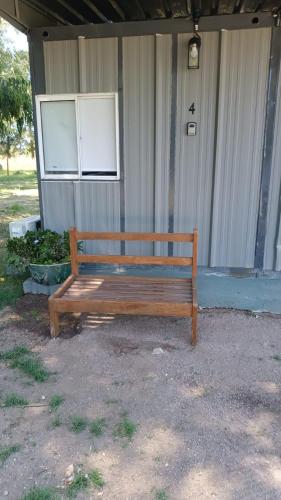 a wooden bench sitting in front of a house at La Martinna 4 in Trinidad