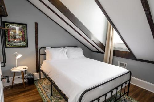 a bedroom with a white bed in an attic at Mandeville Creole Cottage - 3 bed-2 bath in New Orleans