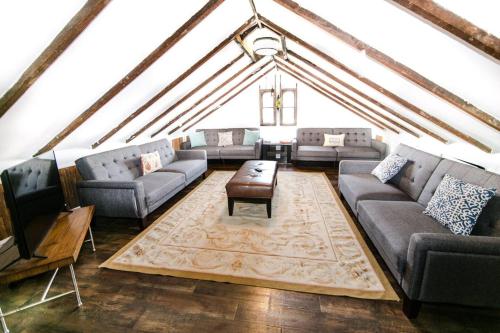 a living room with couches and a tv and a table at Historic Treme Creole Cottage 3 bed-2 bath (C) in New Orleans