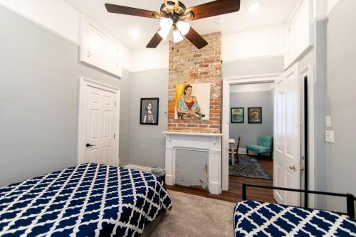a bedroom with a bed and a fireplace at St Ann Creole Victorian - 5 bed-5 bath in New Orleans