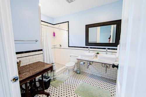a bathroom with two sinks and a toilet at St Ann Creole Victorian - 5 bed-5 bath in New Orleans