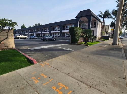 a parking lot in front of a large building at Flamingo Inn in Rosemead