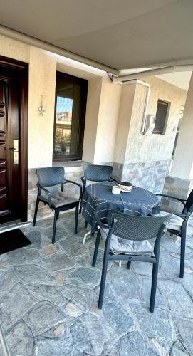 a patio with three chairs and a table and chairs at Emanuela Sea And Luxury in Kavala