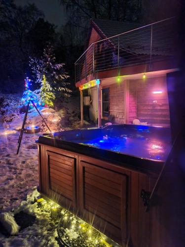 a hot tub in front of a house at night at Panorama view along the fjord in Stryn in Blakset