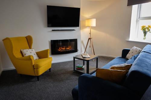 a living room with a couch and a fire place at 35A Coach Street in Skipton