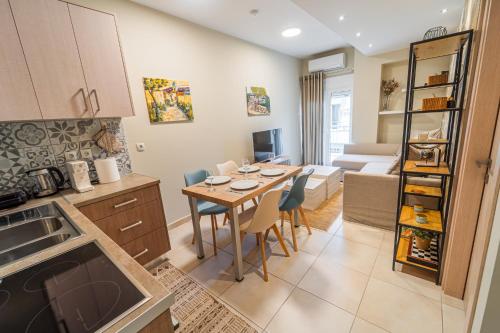 a kitchen and living room with a table and chairs at Ioannina Center Apartment in Ioannina