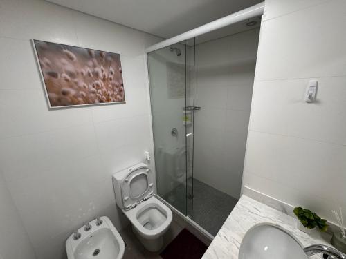a bathroom with a toilet and a glass shower at Punta del Este - Green Life - Top amenities in Punta del Este