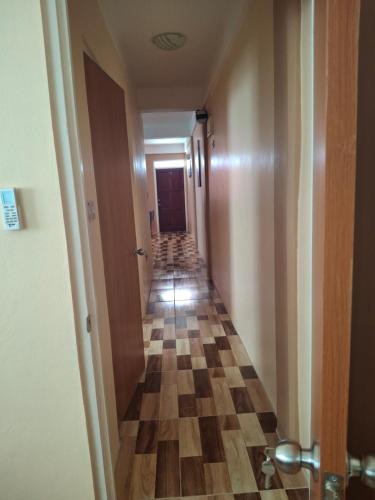 a hallway with a long corridor with a checkerboard floor at 8TN Cozy Apartments in Pointe Michel