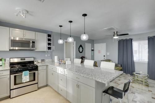 a kitchen with white cabinets and a counter top at North Las Vegas Hideaway with Grill Less Than 10 Mi to Strip in Las Vegas