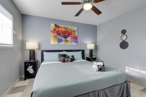 a bedroom with a bed with a ceiling fan at North Las Vegas Hideaway with Grill Less Than 10 Mi to Strip in Las Vegas