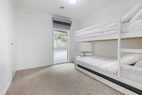 a bedroom with two bunk beds and a window at Peaceful 3 Bedroom Home in Somerville in Somerville