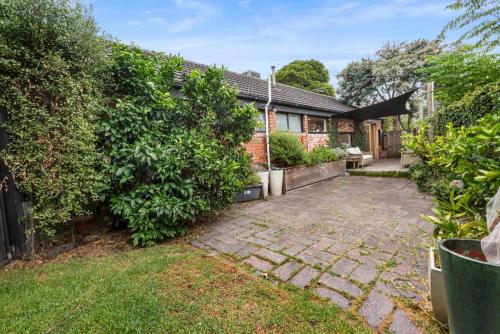 a brick house with a garden and a patio at Peaceful 3 Bedroom Home in Somerville in Somerville