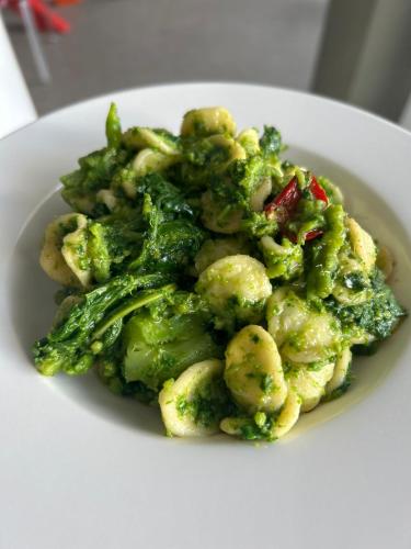 a white plate of broccoli and cauliflower at Dimora del Fragno in Castellana Grotte