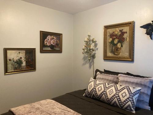 a bedroom with three pictures of flowers on the wall at Dorothy's in Chicago