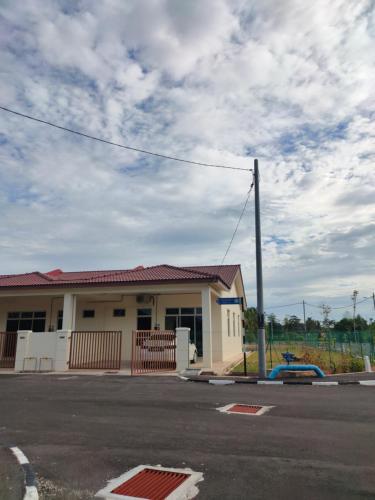 an empty parking lot in front of a building at Puteri Homestay in Kangar