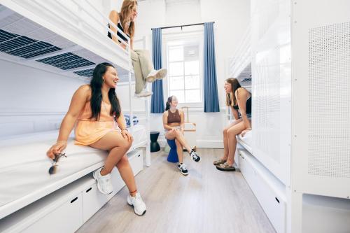a group of women sitting in a dressing room at Maze Backpackers - Gold Coast in Gold Coast