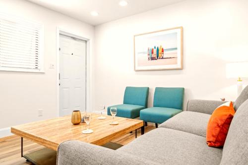 a living room with two chairs and a table at Boutique Beach Retreat in St Pete Beach