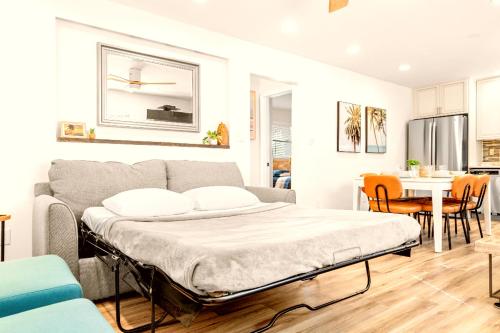 a bed in a living room with a kitchen at Boutique Beach Retreat in St Pete Beach