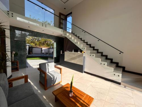a living room with a staircase in a house at OCEAN DRIVE LODGE in Montañita