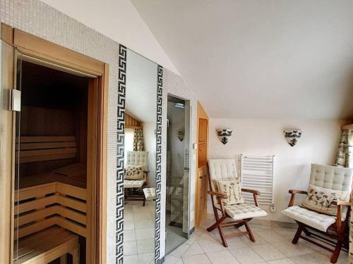 a room with two chairs and a walk in closet at Chalet Lion d'Or in Bagnes