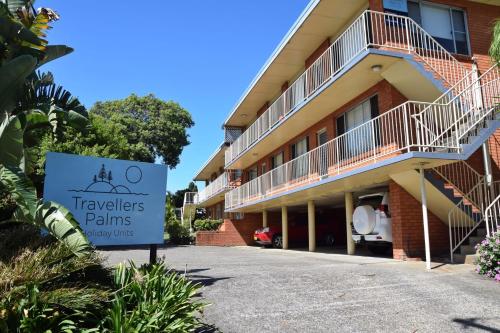 a sign in front of a building with a hotel at Traveller's Palms no 8 - Bring your own linen. in South West Rocks