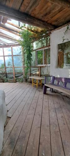 a room with a wooden deck with a bench at El Monte de Baubo Ecocasa in Barra de Valizas
