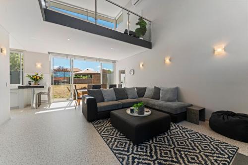 a living room with a couch and a table at Lake Taupo Gem in Taupo