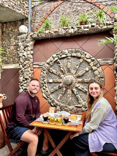 a man and a woman sitting at a table at Sầm Sơn Boutique Hotel Phan Thiết in Phan Thiet
